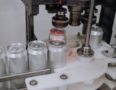 cans being sealed in factory - DemandCaster