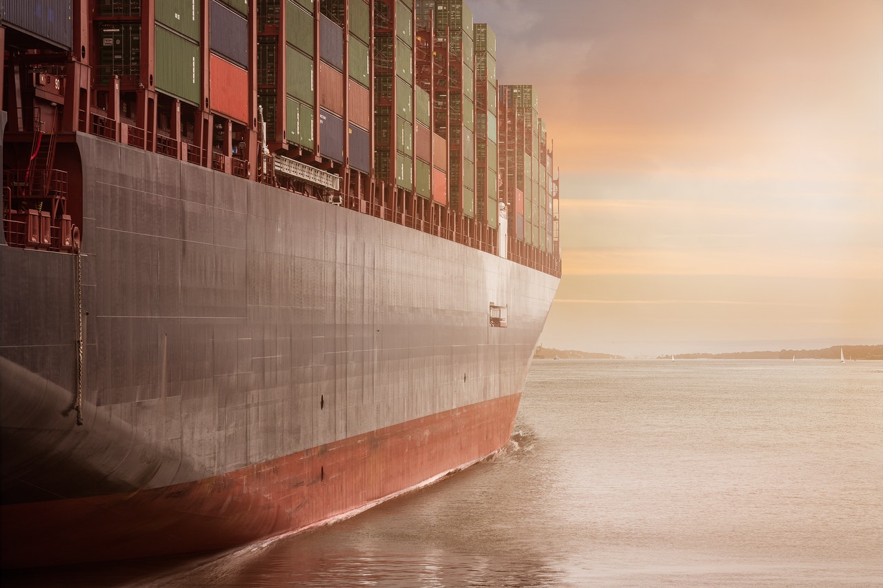 ship sailing on water at sunset