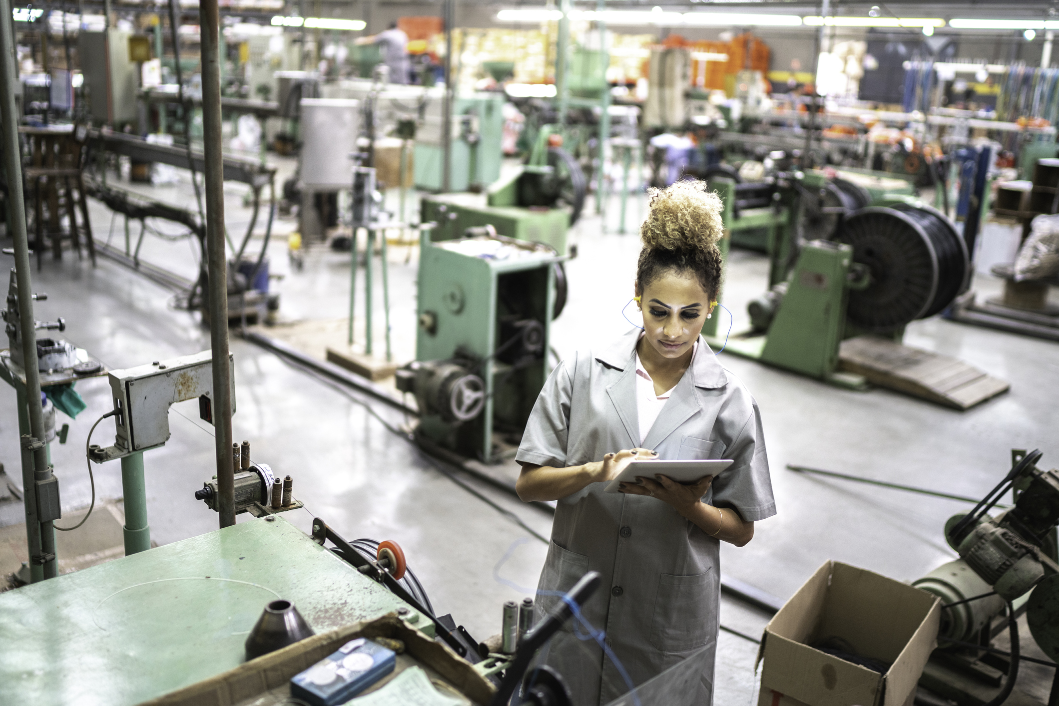 woman using digital tablet in a factory