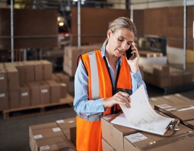 woman looking at paperwork in warehouse